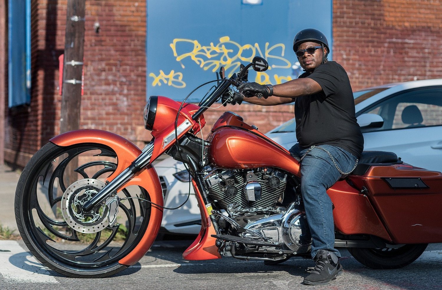 Rider in a Micro Dot helmet on a custom bagger